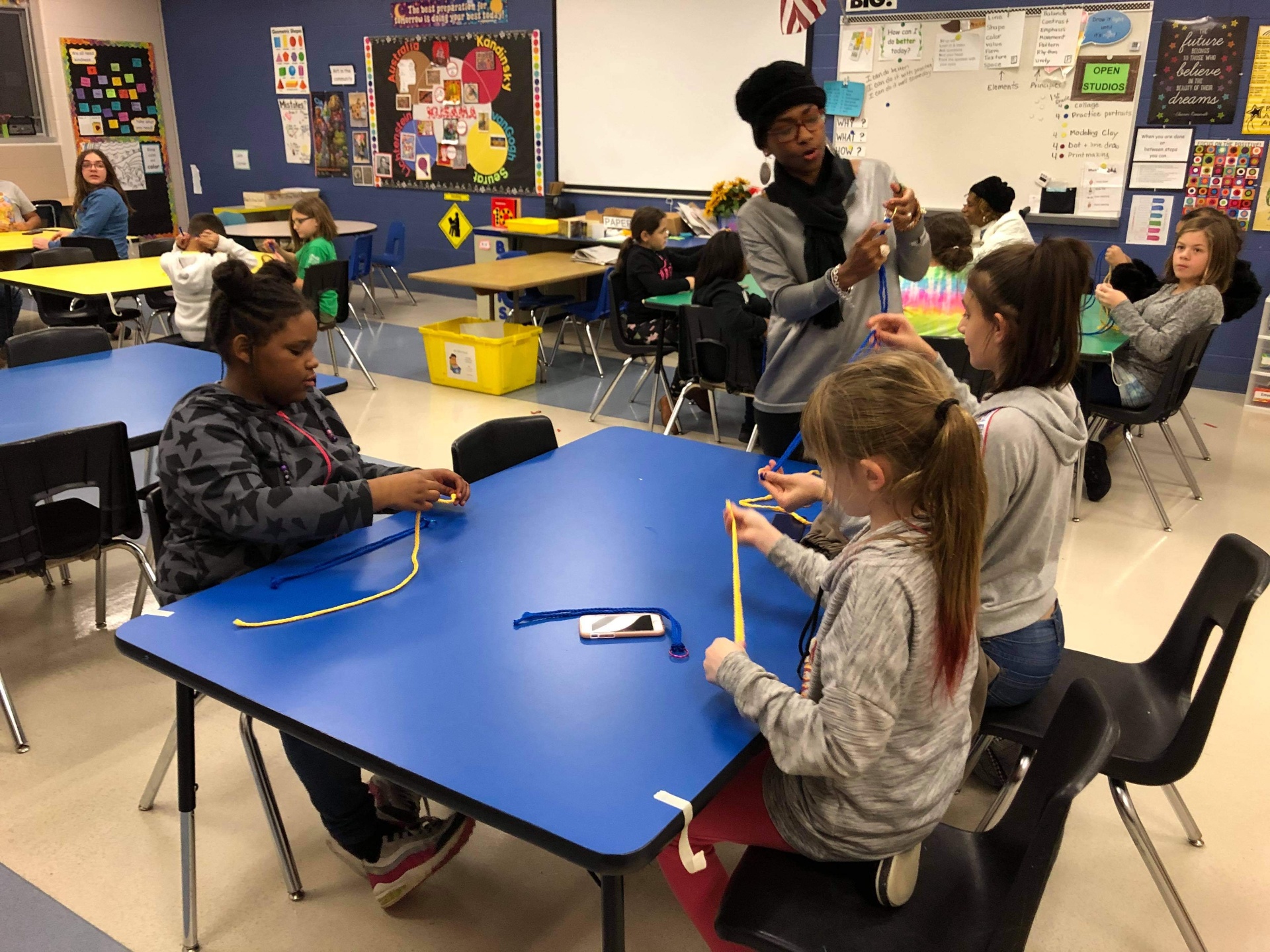 Dr. GwenJ teaching elementary students a yarn-based math activity